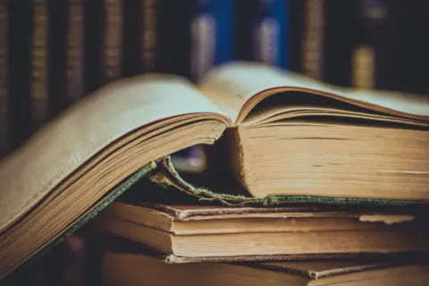 pile-old-opened-books-row-volumes-background-vintage-style-2