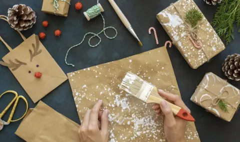 5-top-view-hands-using-paintbrush-christmas-wrapping-paper
