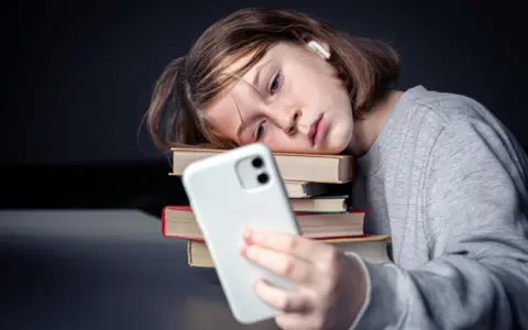 little-girl-sits-near-books-text-1